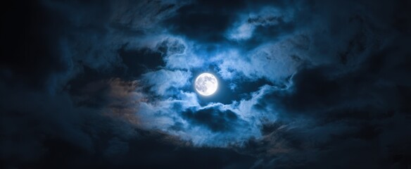 The Enchanting Glow of the Moon Illuminating a Cloudy Night Sky