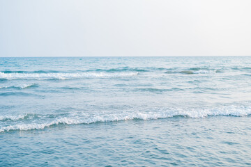 Closeup of the sea at sunset. Beach with sand.