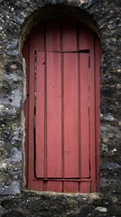 A red door with a wooden frame is open