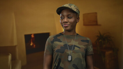 Woman stands smiling in camouflage uniform holding dog tags inside building; confidence service...