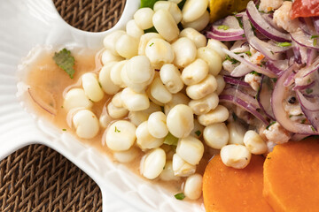 Peruvian ceviche with choclo, sweet potato, red onion, and leche de tigre marinade