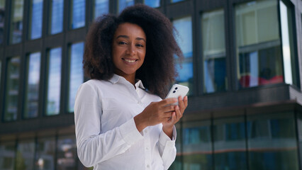African American woman chatting message online digital device using mobile phone smartphone social...