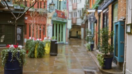 Defocused view of colorful neal's yard in london's winter, featuring blurred storefronts and festive lights.