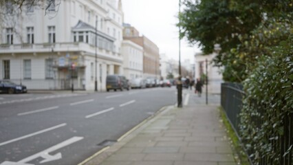 Obraz premium Blurred street view in london during winter features defocused buildings and pavement with a bokeh background, capturing an outdoor urban scene in the uk.