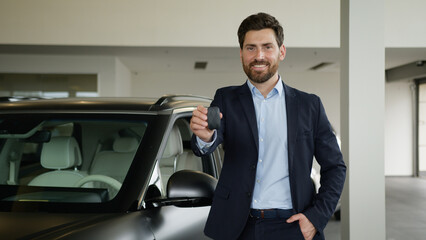Happy Caucasian adult man client buyer auto showroom dealer automobile new car owner male showing...