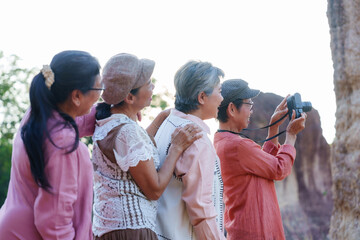 Senior Asian women taking pictures nature landscape smiling cheerful casual clothing outdoor vacation travel adventure lifestyle freedom relaxing refreshing friendship leisure happiness journey