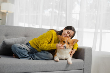 Smiling and friendly Asian female veterinarian examining dog with stethoscope and taking notes on clipboard in clinic. Veterinarian concept.