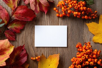 Obraz premium Blank notecard framed by autumn leaves and berries