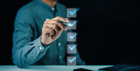 A person in a blue shirt marks checkboxes on a transparent digital interface, symbolizing task completion or decision-making.