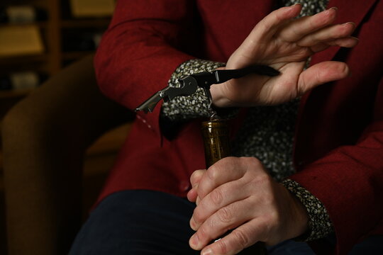 Opening a bottle of white with a wine key