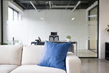 A modern minimalist office space with an industrial ceiling featuring exposed black pipes and ducts. 