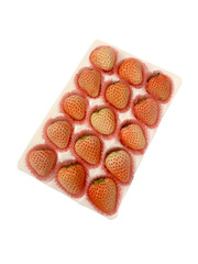 Delicious strawberries packed neatly on a tray, to be sold in supermarket. Top view.