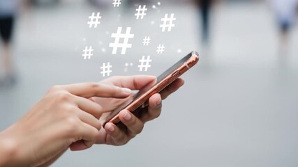 Hands using a smartphone with hashtag symbols floating above, representing social media trends and online communication - Powered by Adobe