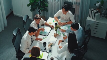 Top view of manager hold tablet display clean energy investment at meeting. Aerial view of skilled...
