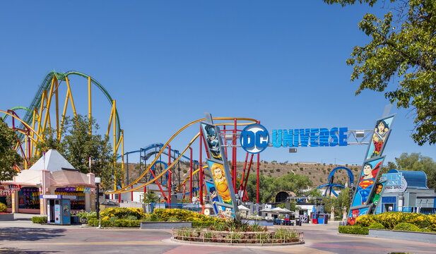 Six Flags California DC Universe amusement park roller coaster attraction, colorful superhero theme, travel destination, entertainment, leisure, adventure, vibrant park entrance scene