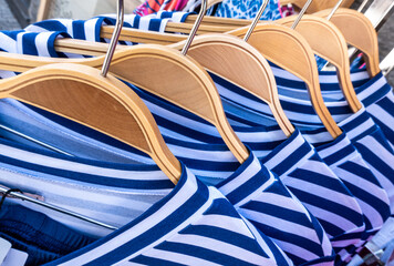 Colorful display of clothing on hangers in a retail store showcasing a variety of styles and...