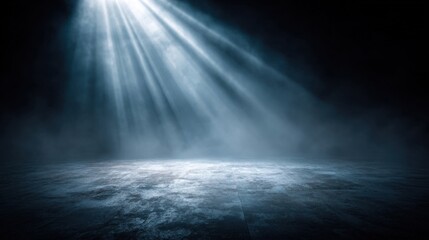 Dark ocean surface illuminated by dramatic rays of light breaking through clouds.