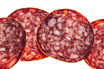 a group of sliced sausages on a white surface