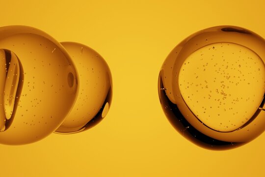 Macro shot of glossy golden spheres with visible internal bubbles, isolated on vibrant yellow background, abstract 3D molecular or cosmetic design for science, biology, chemistry or luxury concepts