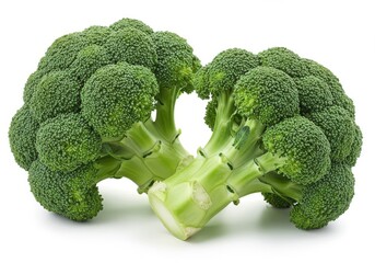 Close up of two heads of fresh green broccoli florets on a plain white surface, healthy eating concept