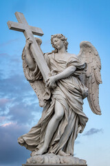 Naklejka premium A marble statue of an angel, among those on the Ponte Sant'Angelo in Rome, Italy. The angel displays the cross on which Jesus Christ was crucified.