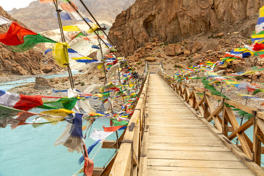 Suspension bridge adorned with colorful prayer flags