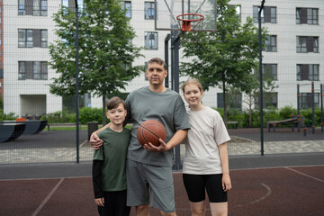 Family bonding on outdoor basketball court