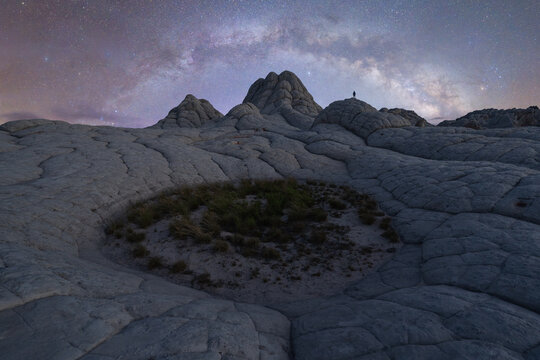 Man beneath Milky Way at White Pocket Arizona nightscape