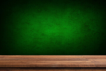 Wood table on dark green texture wall background. Composition with window shadow on bottle green wall. Mock up for presentation, branding products, cosmetics food or jewelry.