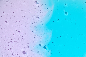 Colorful cosmetic gel droplets with purple and blue hues