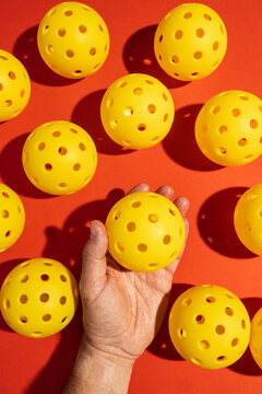 Top view of pickleball balls in a studio shot on orange
