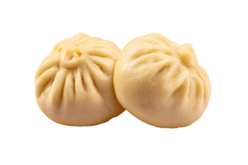 two dumplings are sitting on a white surface