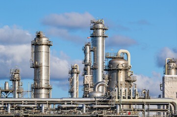 Pipes, pipelines, and cooling towers at an oil refinery power station infrastructure for energy...
