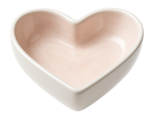 A small ceramic heart dish for storing jewelry on a dresser in a master bedroom.