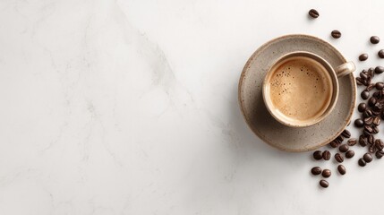 Aromatic coffee cup with frothy crema on a ceramic saucer and scattered coffee beans on white marble background.