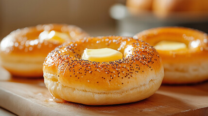 Freshly baked bagels topped with butter