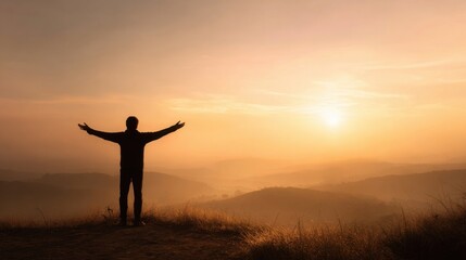Fototapeta premium Silhouette of a Person Standing with Arms Outstretched at Sunrise over Mountain Landscape.