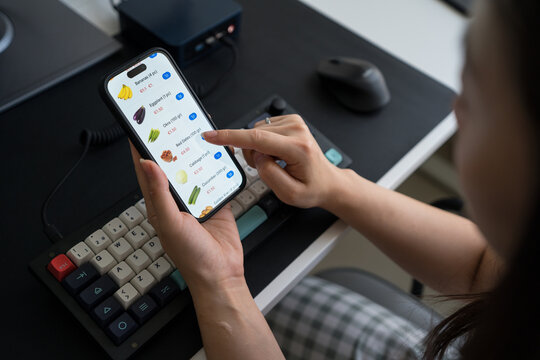 Unrecognizable woman shopping groceries online at home