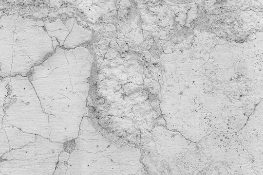 Textured white concrete surface with cracks and details