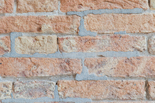 Fototapeta Textured brick wall with rough surface details