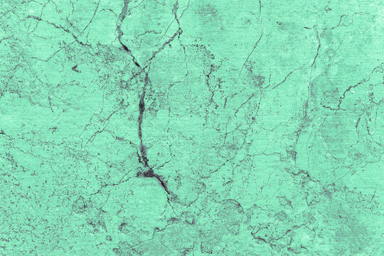 Cracked turquoise textured stone surface close-up