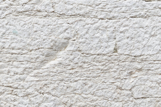 Close-up of rugged white stone texture background