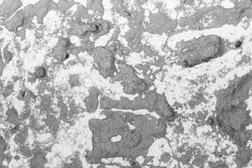 Rough gray textured concrete wall with peeling paint