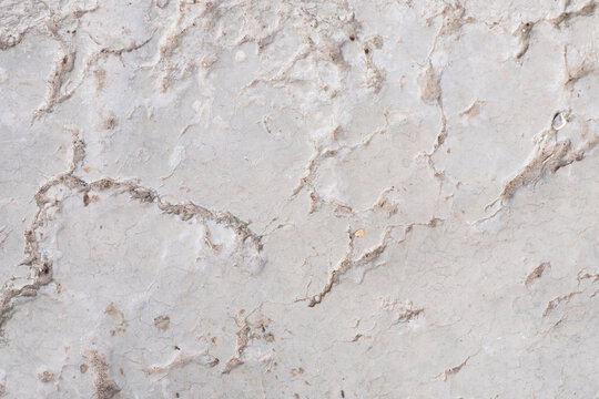 Textured surface of grey cracked stone background