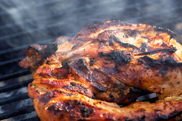 Pork chops, steak, sausages on barbecue grill