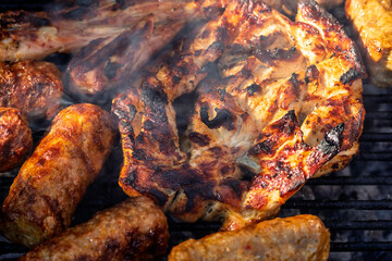 Pork chops, steak, sausages on barbecue grill
