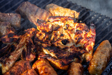Pork chops, steak, sausages on barbecue grill