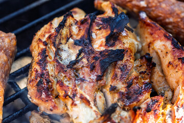 Pork chops, steak, sausages on barbecue grill