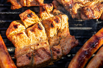 Pork chops, steak, sausages on barbecue grill