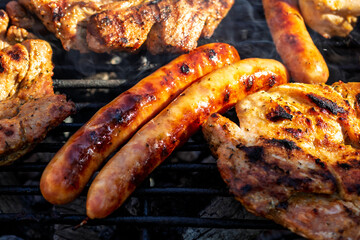 Pork chops, steak, sausages on barbecue grill